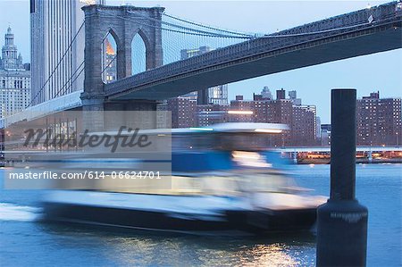 Blurred view of boat on urban river