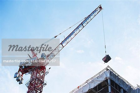 Crane loading equipment on building