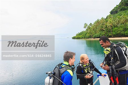 Scuba divers talking on boat