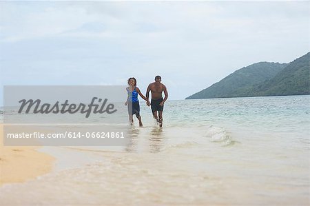 Couple walking on tropical beach