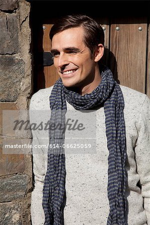 Smiling man wearing scarf outdoors Smiling man wearing scarf outdoors