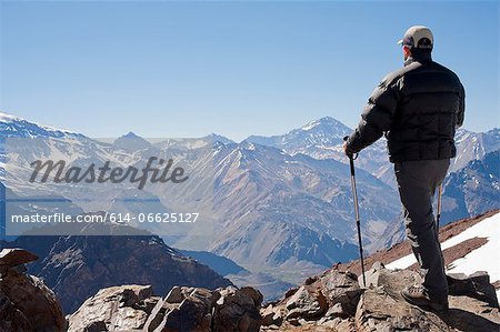 Hiker overlooking snowy mountains Hiker overlooking snowy mountains