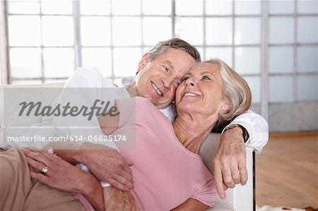 Older couple relaxing on sofa