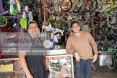 Mechanics smiling in bicycle shop