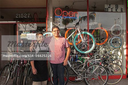 Mechanics outside in bicycle shop