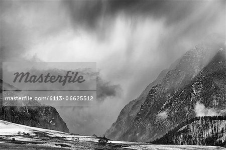 Clouds over snowy rural landscape