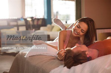 Couple relaxing on bed together