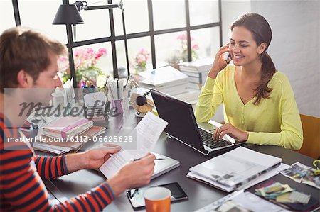 Couple working together at desk Couple working together at desk