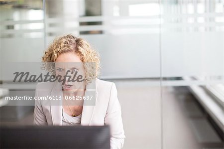 Surprised businesswoman working in office