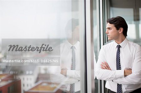 Businessman looking out office window