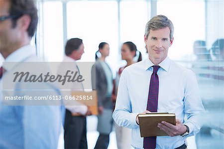 Businessman smiling in office hallway