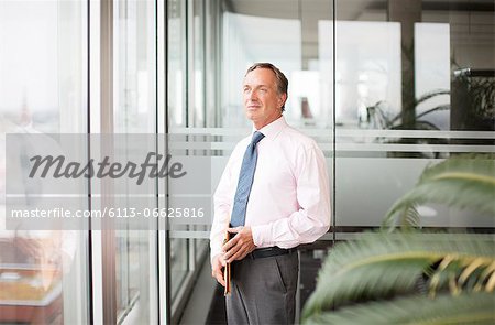 Businessman standing at office window