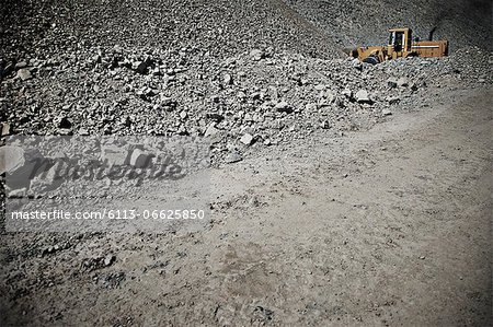 Digger driving in quarry