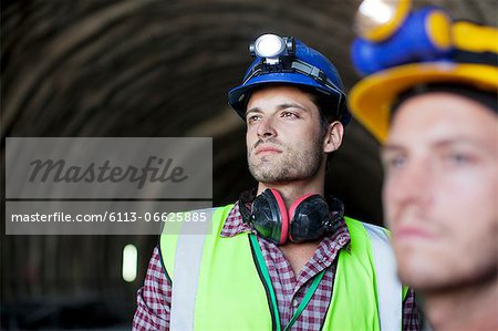 Workers looking out from tunnel