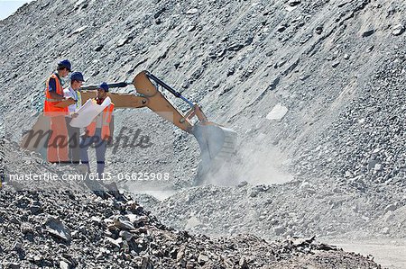 Workers and businessman talking in quarry