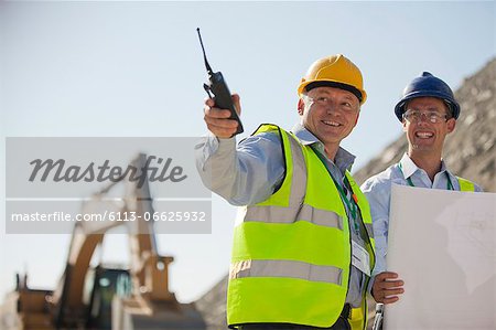 Businessmen talking in quarry