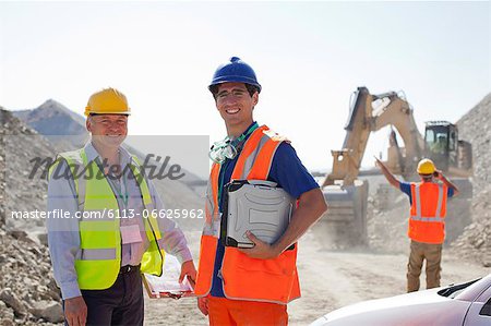 Worker and businessman standing in quarry