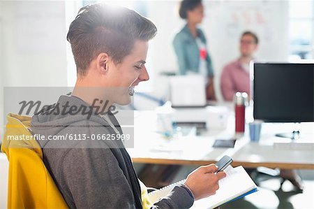 Man using cell phone in office