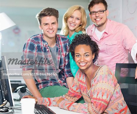 Business people smiling at desk