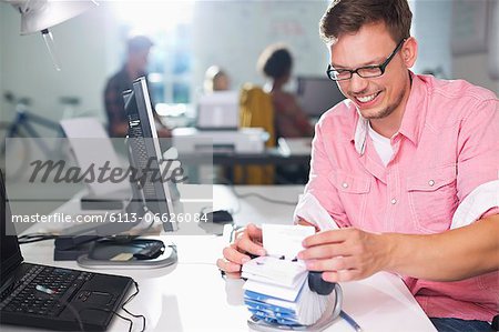 Businessman looking up address in office