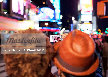 Couple taking picture together on city street