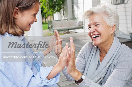 Woman and granddaughter playing clapping game