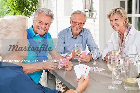 Friends playing card games at table