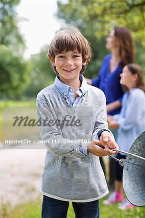 Boy swinging pail outdoors