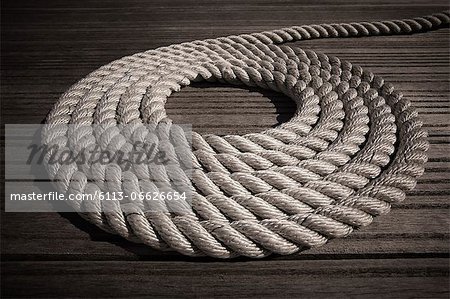 Rope coiled in circle on boardwalk