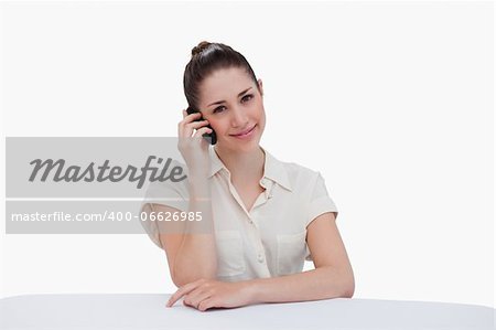 Happy businesswoman making a phone call against a white background