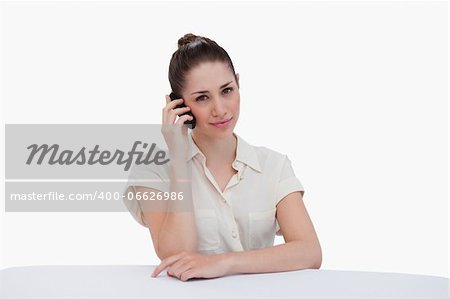 Cute businesswoman making a phone call against a white background