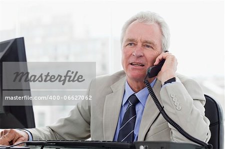 Senior manager on the phone in his office