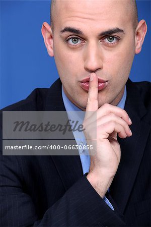 Man holding a finger to his lips