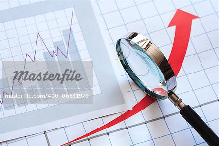 Business concept. Magnifying glass on paper background with chart