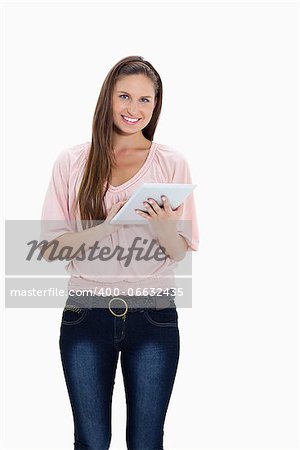 Smiling girl using a touchpad against white background