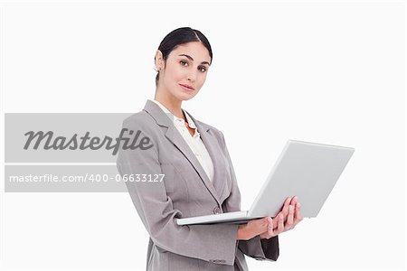 Side view of businesswoman with laptop against a white background