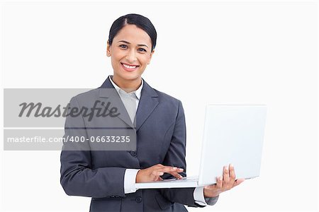 Close up of smiling saleswoman with her notebook against a white background