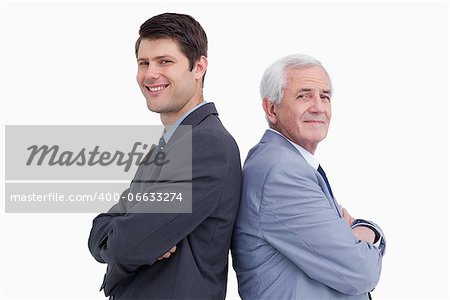 Close up of businessman and his mentor standing back to back against a white background