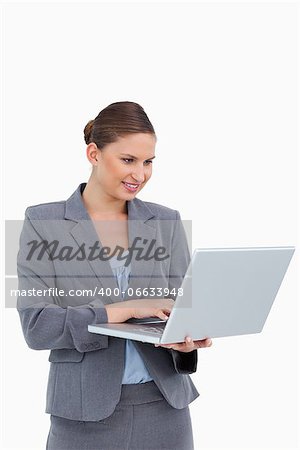 Tradeswoman working on her laptop against a white background