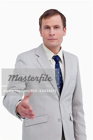 Businessman offering his hand against a white background