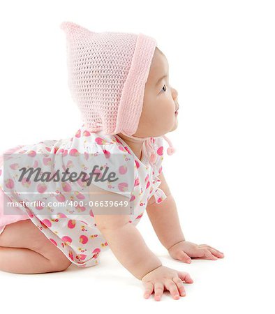 Six months old East Asian baby girl crawling on white background