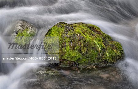 Rock.Fast-flowing water background, long exposure