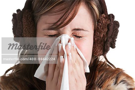 Pale sick woman with a flu, sneezing, in a white background