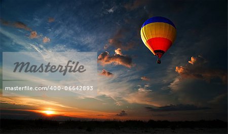 Colorful hot air balloon is flying at sunrise