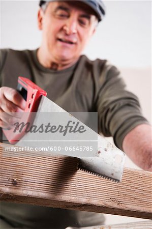 Man Cutting Lumber, Woodworking Project, in Studio