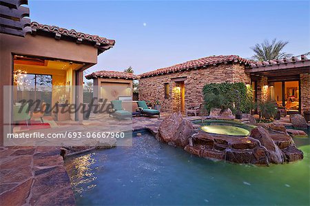 House Exterior with swimming pool and hot tub