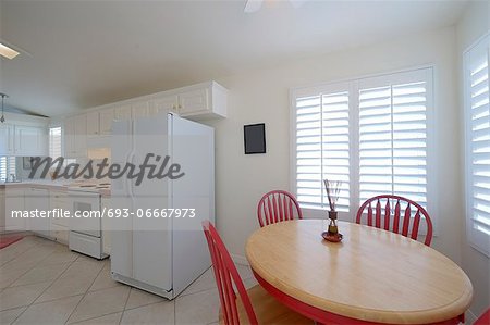 Classic kitchen with dining table with red chairs