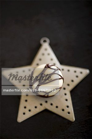 A white chocolate praline on a Christmas star