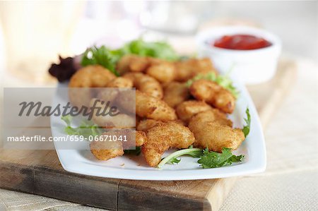Platter of Fried Popcorn Shrimp; Bowl of Cocktail Sauce in the Background