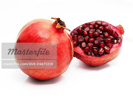A whole and half pomegranate A whole and half pomegranate